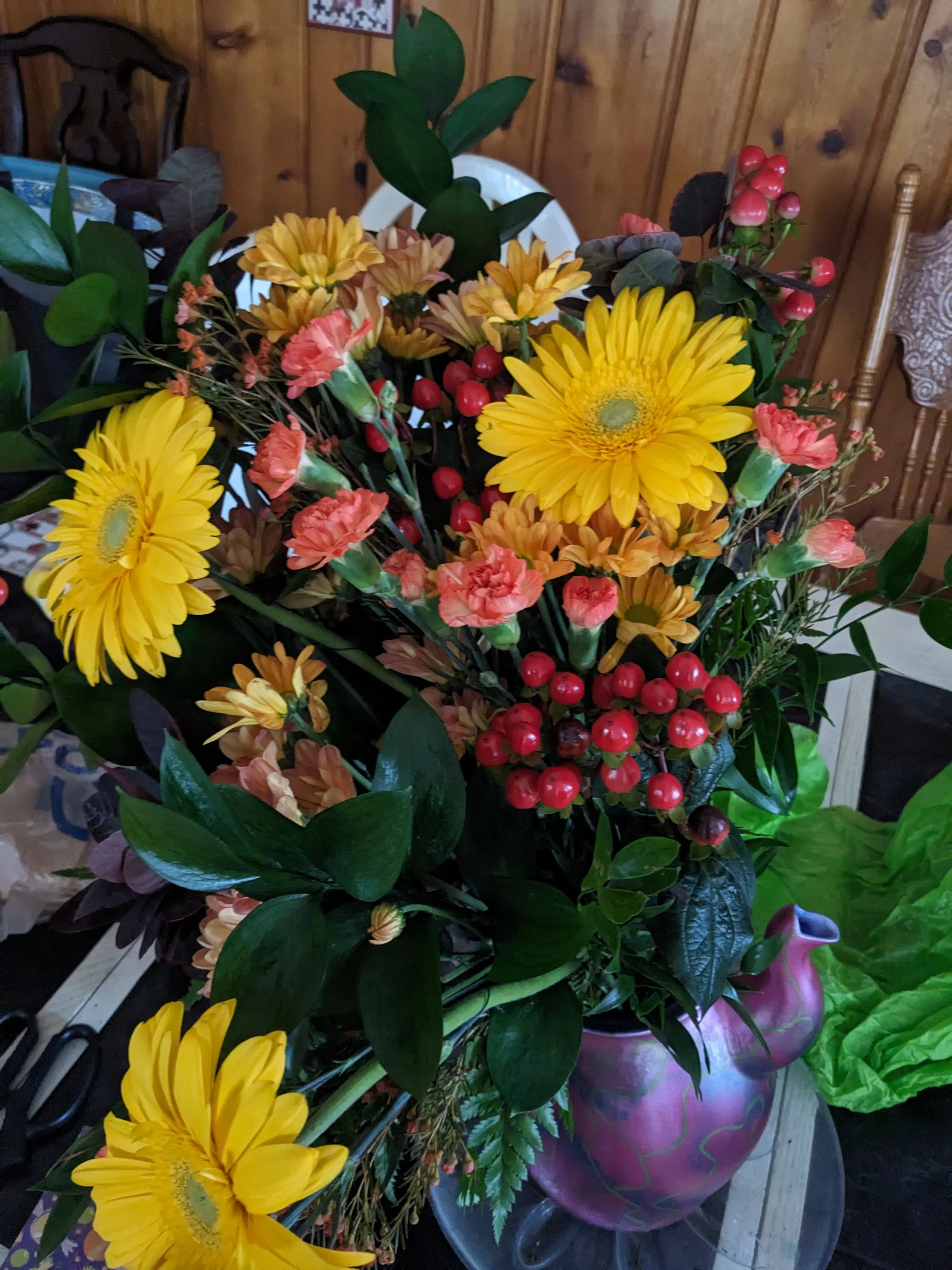 Altar floral arrangement of yellow daisies, peach carnations, and red berries for Sunday worship at Christ Church Glendale, Ohio.