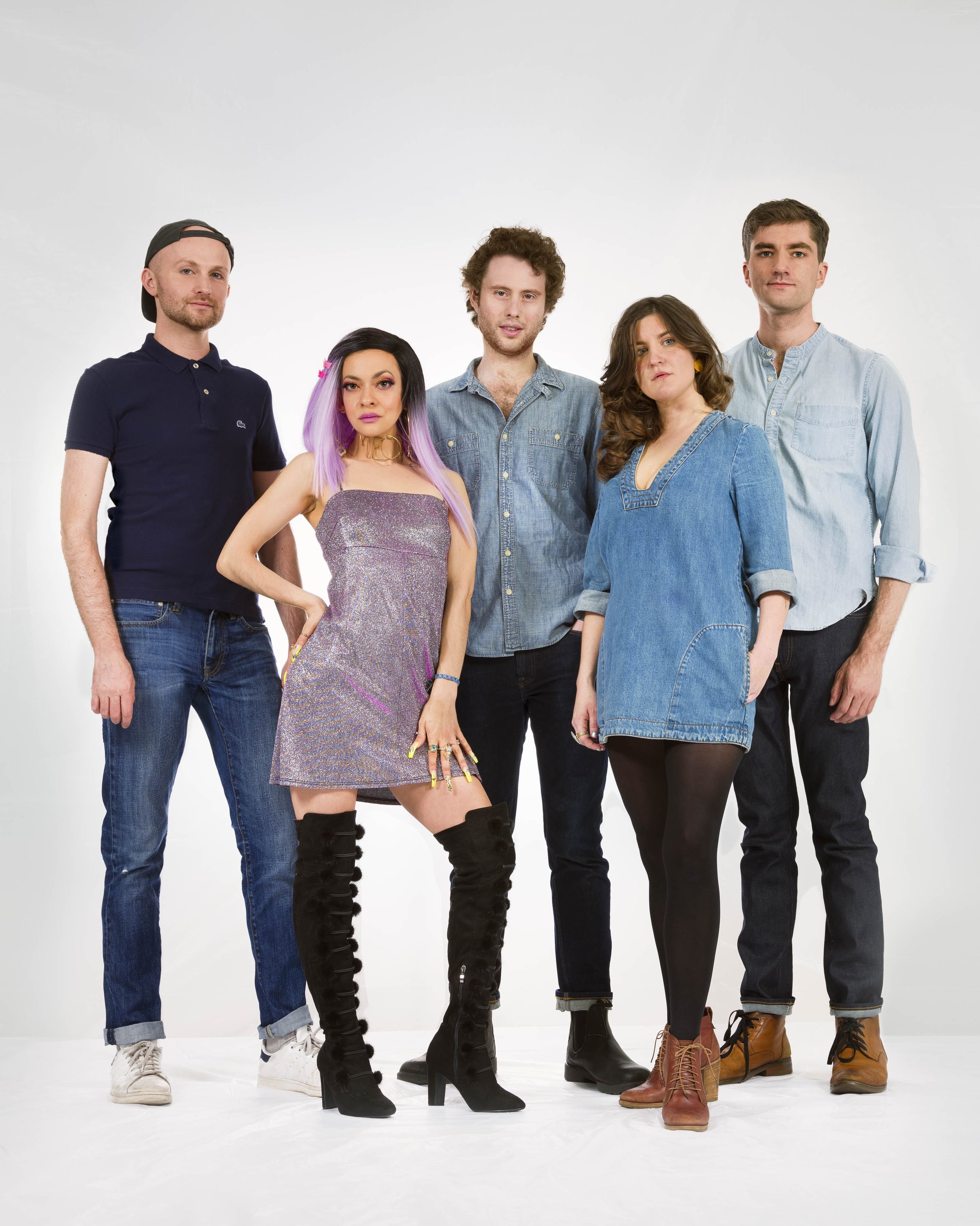 Group photos of theater production group Fake Friends standing in front of white background. From right to left: Michael Breslin, Catherine María "Cat" Rodríguez, Patrick Foley, Ariel Sibert, Rory Pelsue