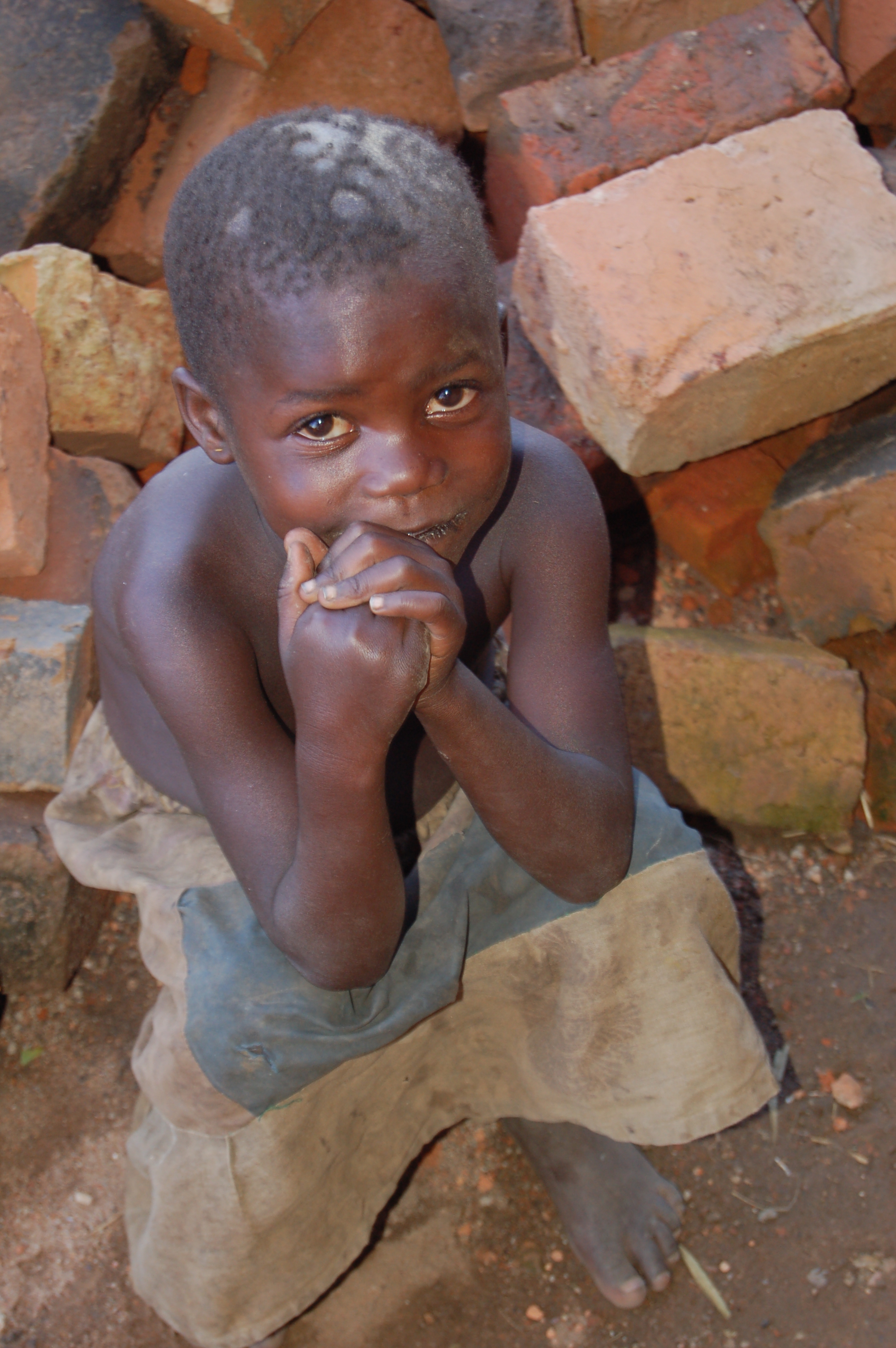 Young Child Sitting on Bricks.jpg