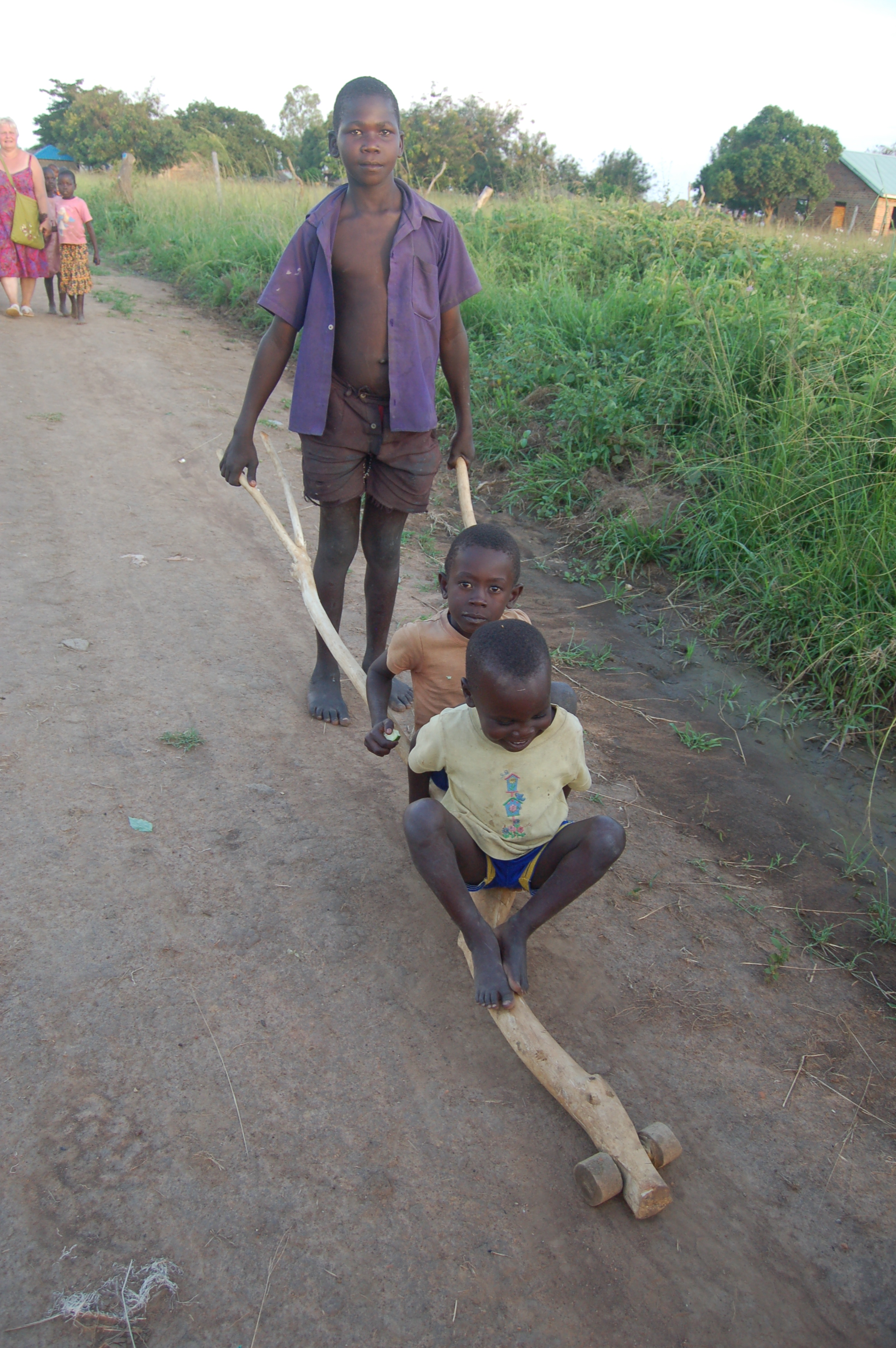 2 children + makeshift wheel barrow.JPG