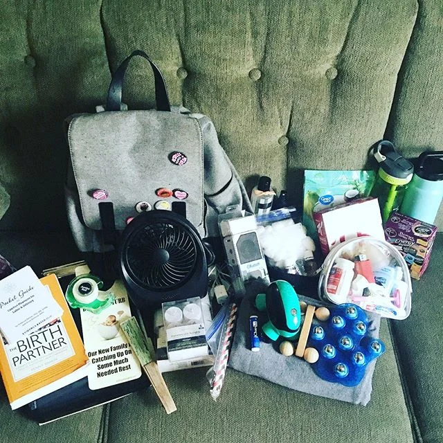 Gearing up for an expected long labor! So, What’s In My Doula Bag? 👇🏼 -Paperwork -Birth Literature -Door Sign -Scotch Tape -Portable Fans -Flameless Candles -Straws -Bluetooth Speaker -Charging Cables -Chapstick -Rebozo -Massage Tools -Essential Oils -Cotton Balls -High Protein Snacks -Personal Care Items -A Bottle of Cold Water -A Thermos of Strong Coffee -Camera (not pictured)
The bag varies a little Birth to Birth, But this is a pretty good idea of what lies within our Mary Poppins bag of wonder! ✨💗🤰🏽🤱🏻💗✨