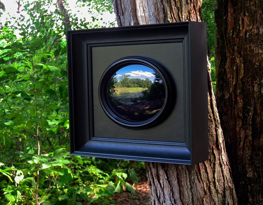 A four-part outdoor installation based on the Claude glass, an 18th-century device for viewing picturesque landscape which required the user to turn his back on the view. The work consists of four framed black convex mirrors installed vertically at