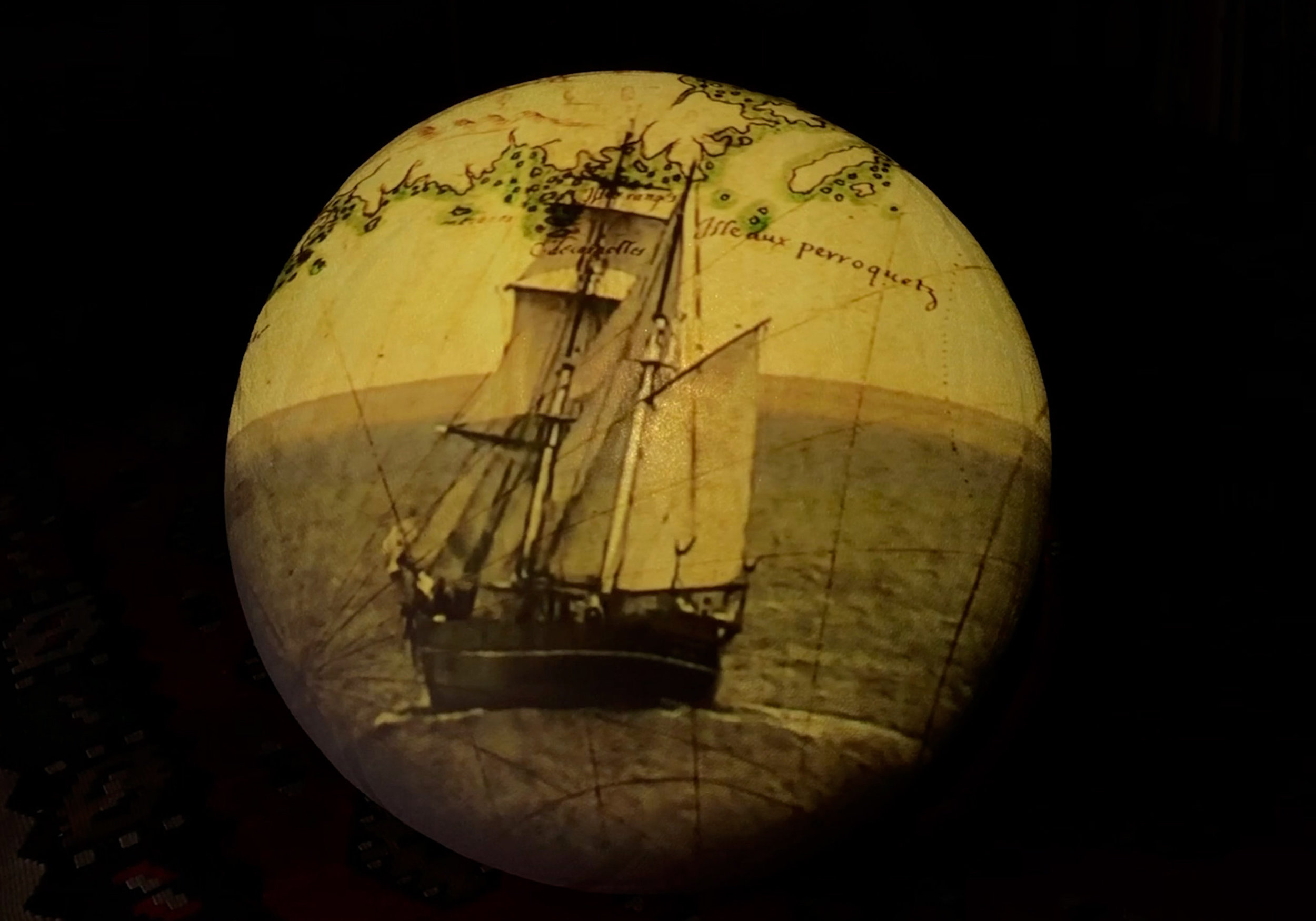 Titled after the first modern European world atlas , Theatrum Orbis Terrarum (Theatre of the World) is a video installation consisting of four videos projected sequentially onto four large (90 cm) white globes. Its design references and models a se