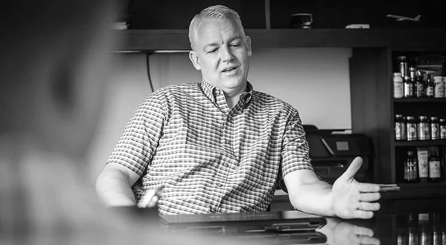 Blake Christensen telling a story at his desk in the Nutra Connection corporate office.