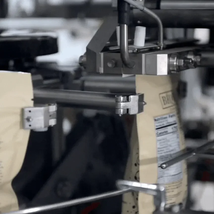 GIF of an automated co-packing machine sealing pouches of powder.