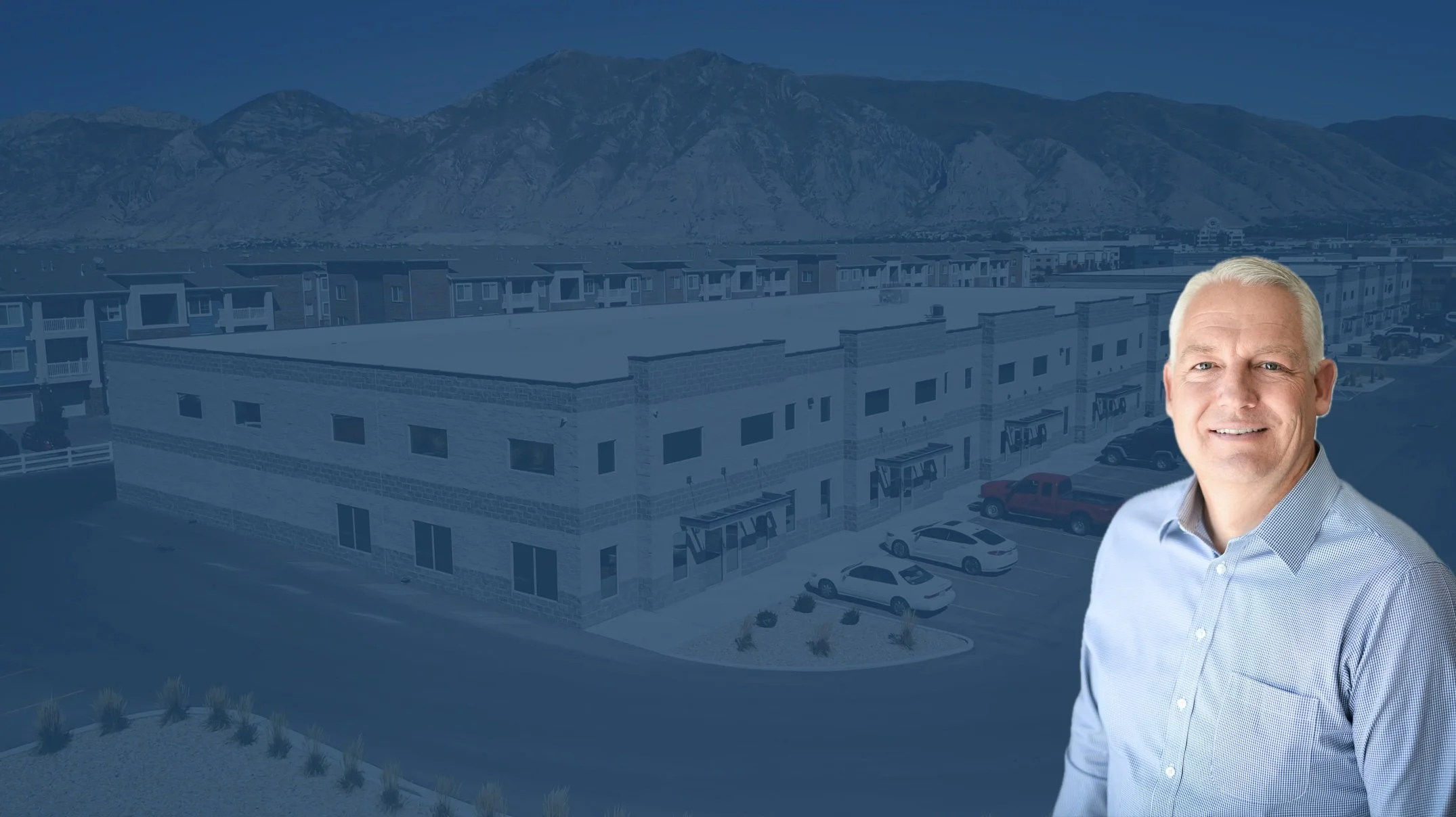 Blake over semi-transparent blue background with the manufacturing facility.