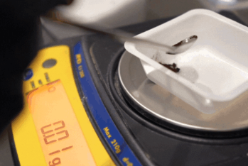 Powder being weighed on a small scale in the R&D lab