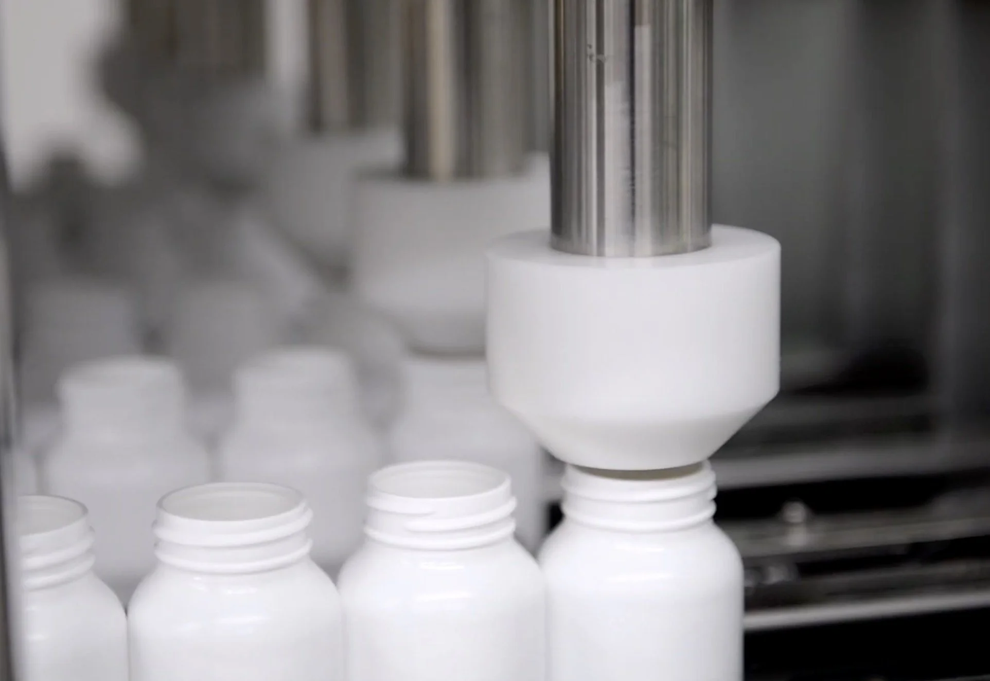 Bottles being automatically filled with capsules.