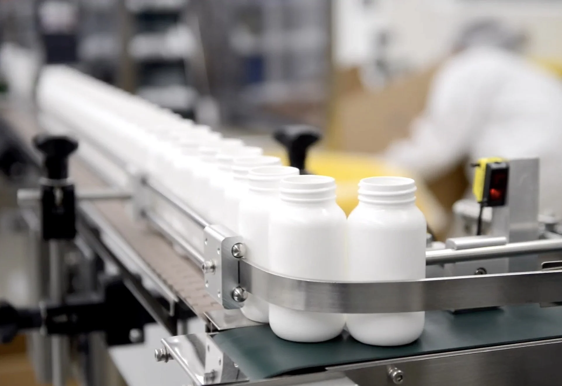 White bottles going through the bottling line.