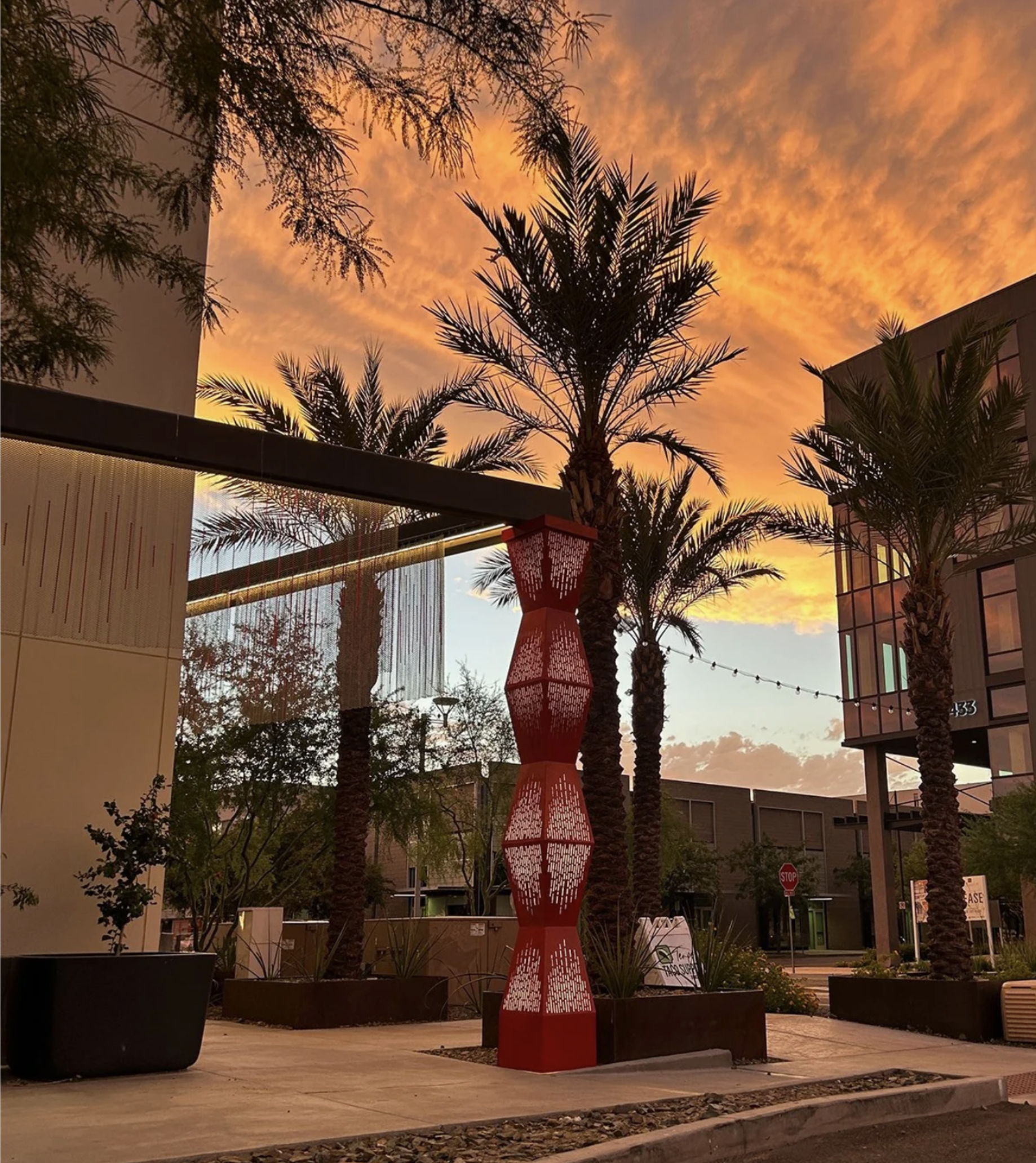 Artwork surrounding the Vīb Hotel features illuminated pillars with vibration pattern and a continuous stainless steel curtain. Vibrations produced by a spoken poem have been translated into a sound graph that is woven into the metallic drapery.