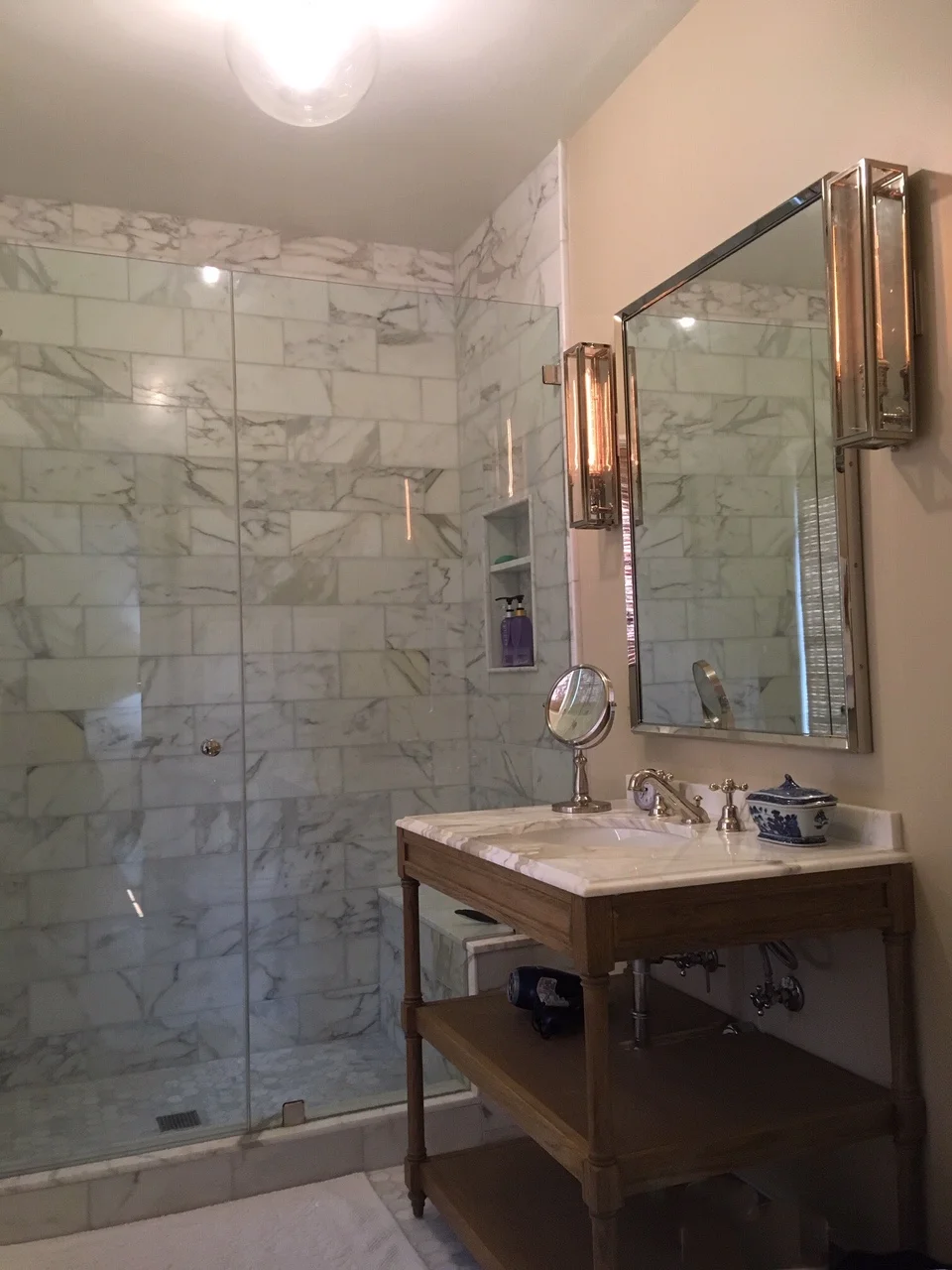  RIVIERA RESIDENCE  Full bathroom remodel using different cuts of Calcutta Gold marble. Lime washed oak vanity enhances the warm hues naturally occurring in the stone. 