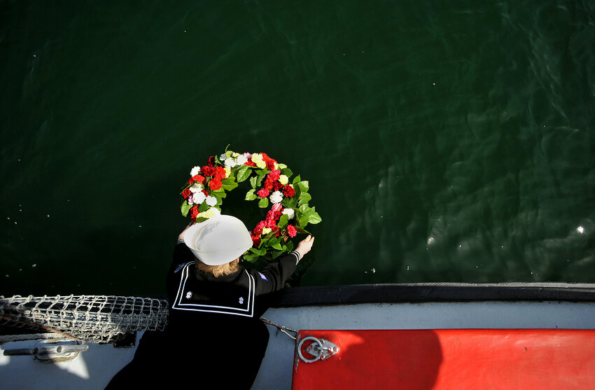  Blaine Sea Scout Luke Greene, 16, lowers a wreath into the water that was created at the annual Blessing of the Fleet Sunday afternoon, May 1, 2011, just offshore of the Blaine Harbor Marina Boating Center in Blaine, Wash. The ceremony is put on by 
