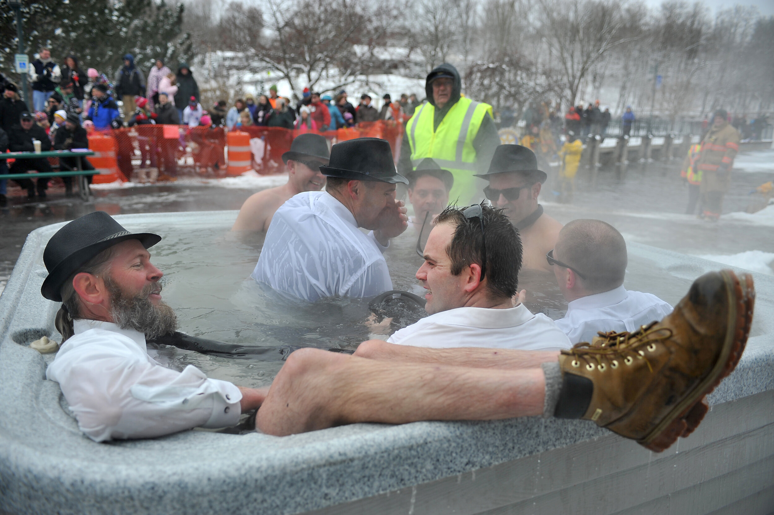  Not wanting to take off his boots, Scott Galloway relaxes with his feet kicked up on the hot tub after battling the near-zero temperatures while participating in the Sweetheart Splash Saturday, Feb. 11, in Rockford. 
