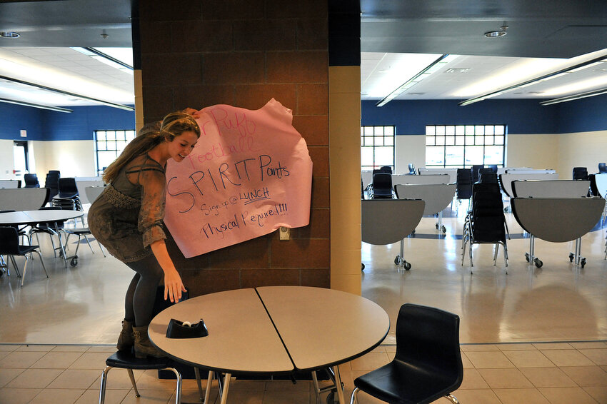  Keara Kilbane puts up a sign for powder puff football sign ups Wednesday, Oct. 5, 2011, in the lunch room of Hopkins High School. Kilbane is part of the student council and the organizer for the event, which benefits the Wounded Warrior Project. 