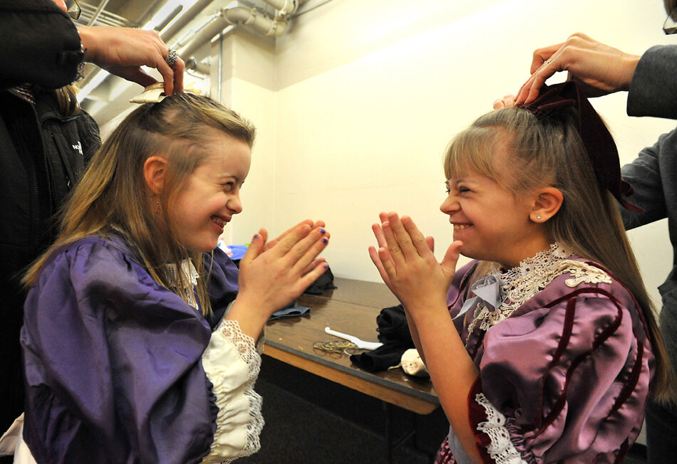  Maggie Fischer, 15, left, and Annah Huisman, 10, right, get their hair done by their moms, Virginia Fischer and Lisa Huisman, as they get ready before a dress rehearsal for the Nutcracker Ballet Thursday, Dec. 8, at DeVos Performance Hall in Grand R