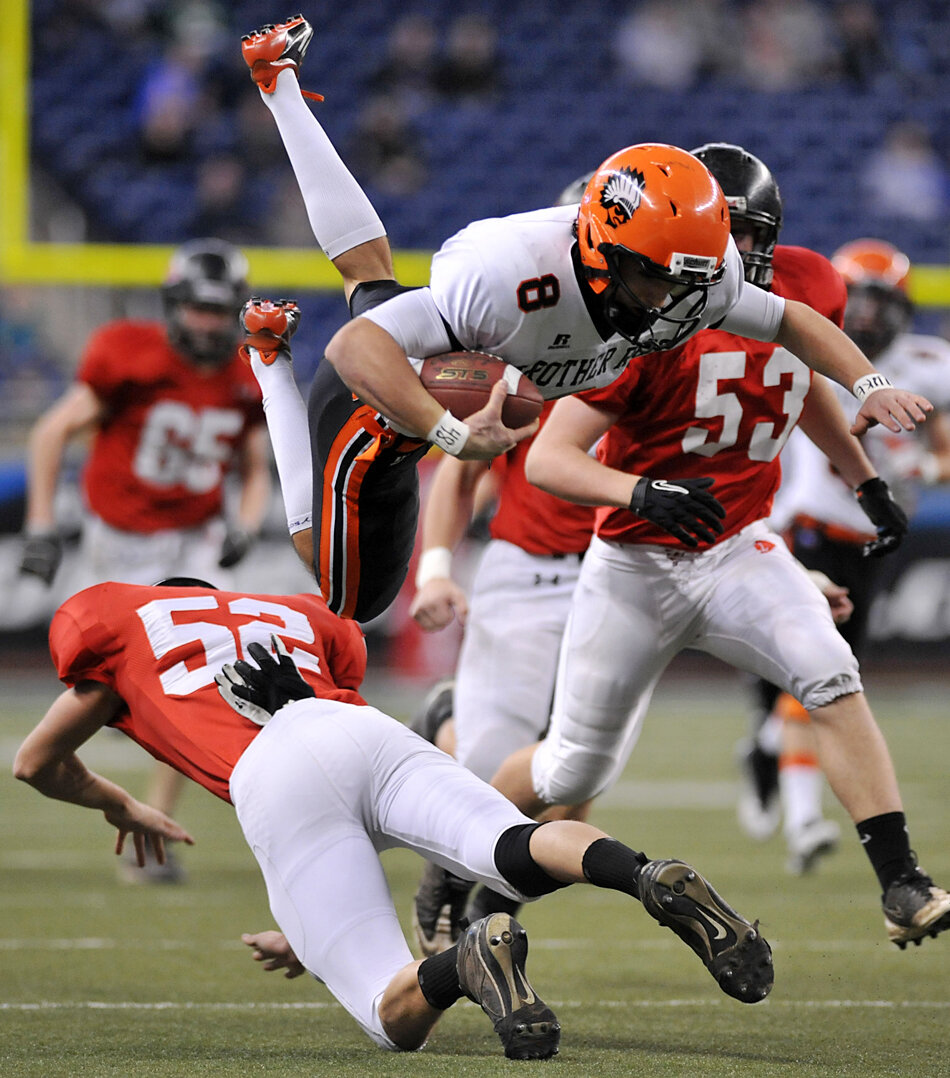 Lowell's Jordan Drake upends Birmingham Brother Rice's Brian Roney in the Division 2 state championship game Friday, Nov. 25, at Ford Field in Detroit. Lowell lost the game 24-14. 