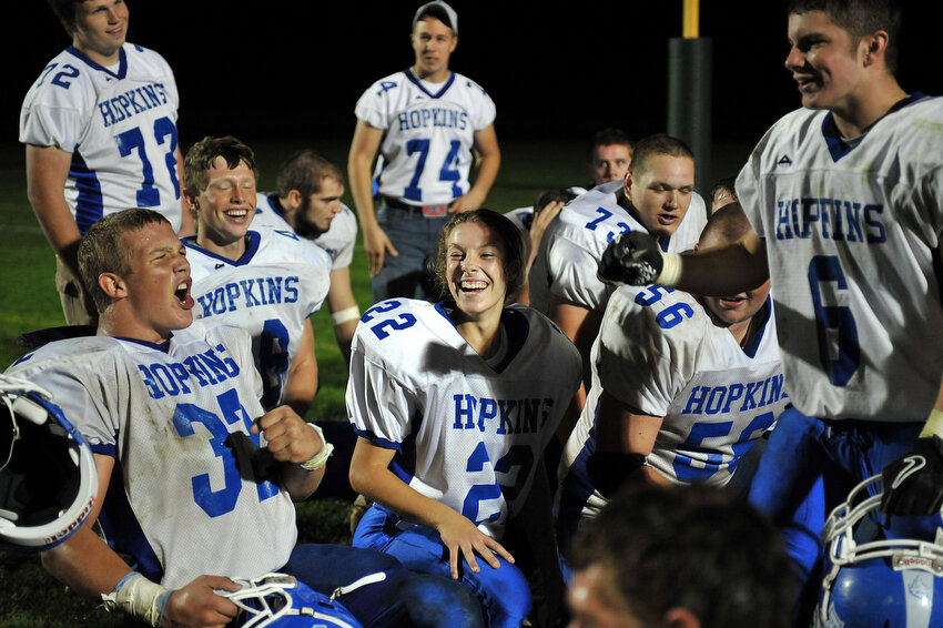  Keara Kilbane, center, laughs with her teammates as Joey McPeak, left, yells in celebration of winning against Calvin Christian, the biggest game of the season, Friday, Oct. 7, 2011, in Grandville. 
