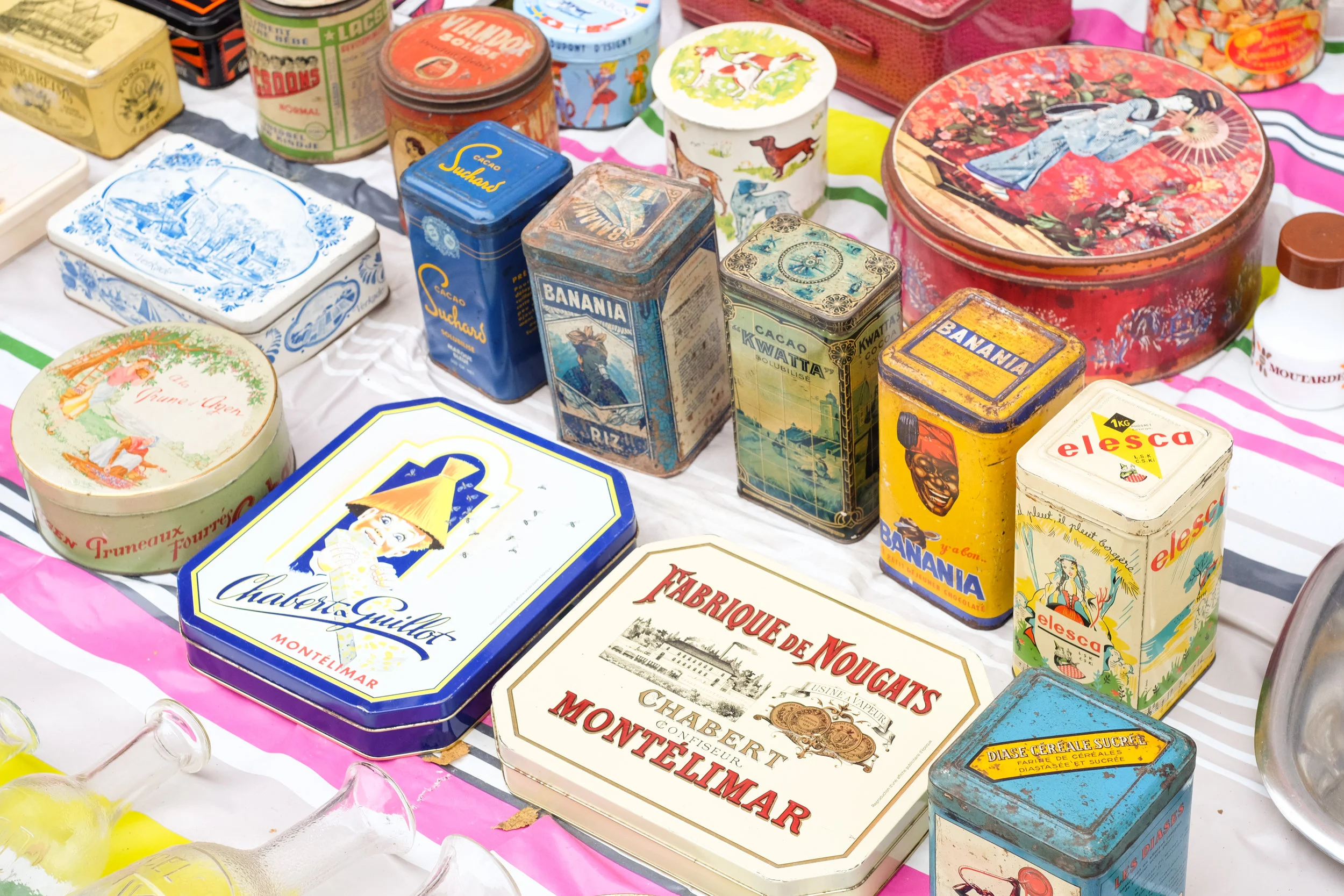 Brightly colored tins in many shapes and sizes