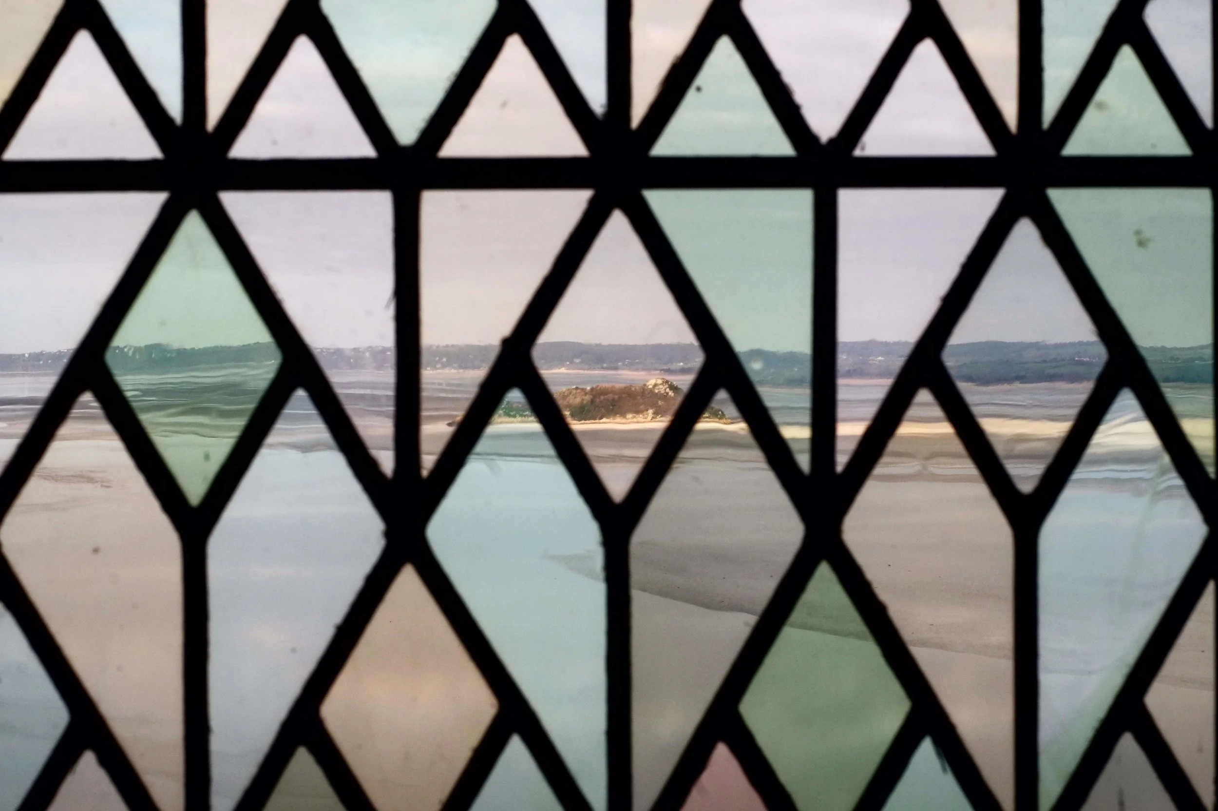 Views of the ocean through the stained glass windows of the abbey