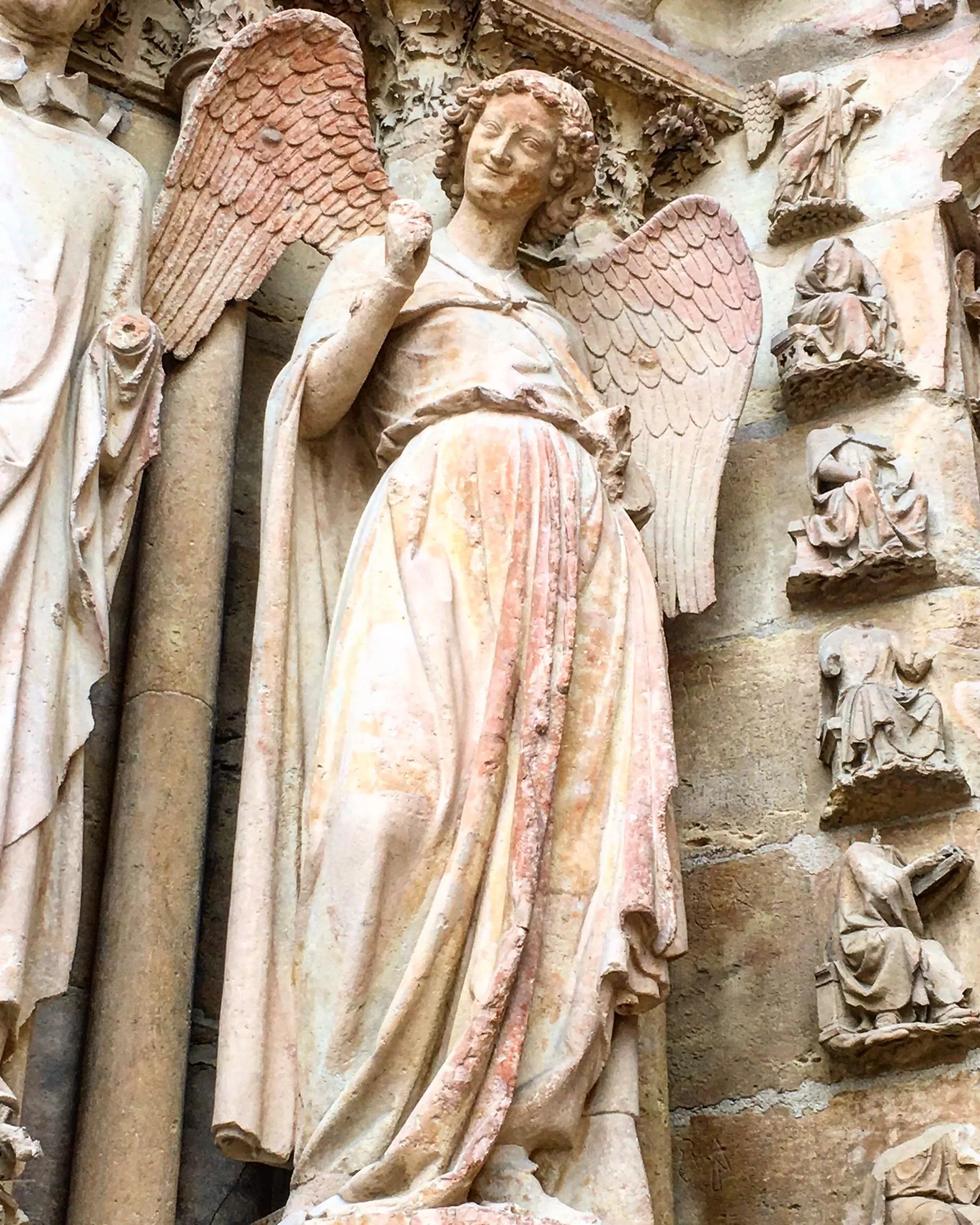 Restored after suffering damage during WWI, the ange au sourire still stands for us to enjoy today. This smiling angel is famous because her jovial smile contrasts the more serene expressions we typically see.
