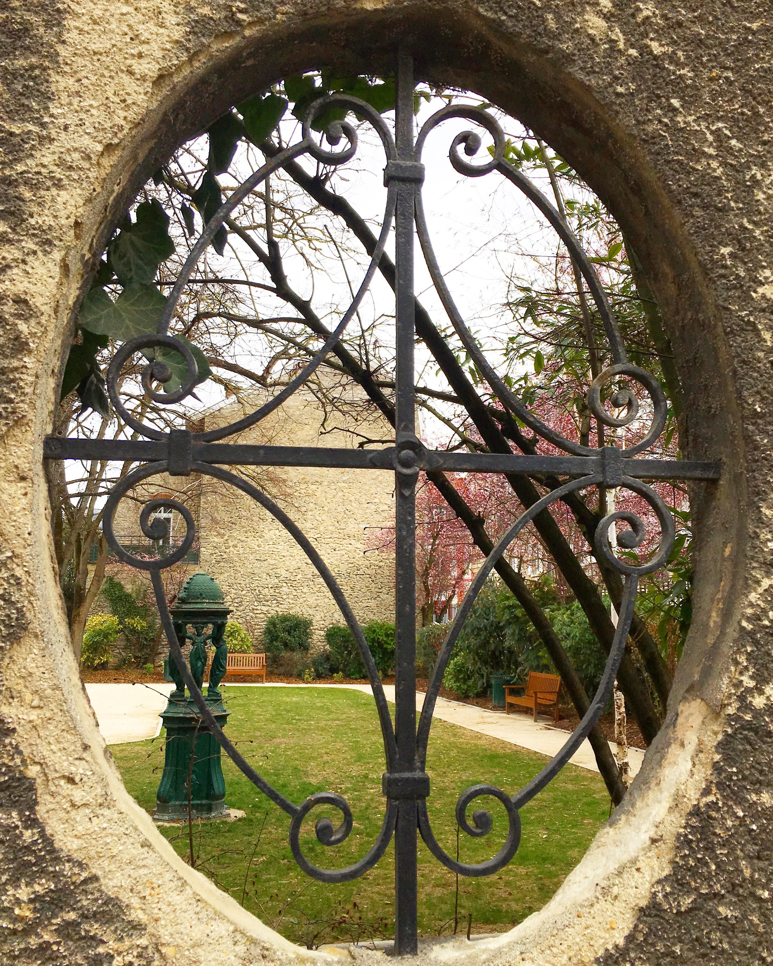 One last image I captured as we explored the streets of Reims. I loved catching a glimpse of this courtyard through the swirly wrought iron window. The pink blossoming tree is proof that spring is coming. The green fountain with four ladies known as a Wallace fountain was designed in the 1800s to give people easier access to clean drinking water.