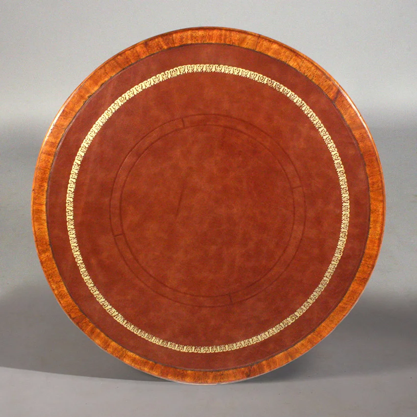 Drum table top after restoration. Tooling the table’s distinctive pattern was an intricate and demanding process complicated by the fact that the “round” table wasn’t wholly round. With appreciation for fine leather-tooling (and the sophisticated eye to note the difference between commercial leather stamping) the client requested duplication of original aesthetic by hand.