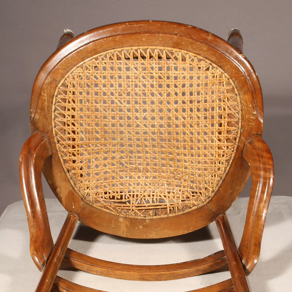 Caned seat with visible damage