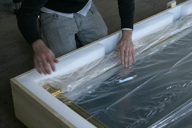 Wrapping the conserved giltwood framed mirror placed in a professionally designed custom crate with appropriate padding cavity