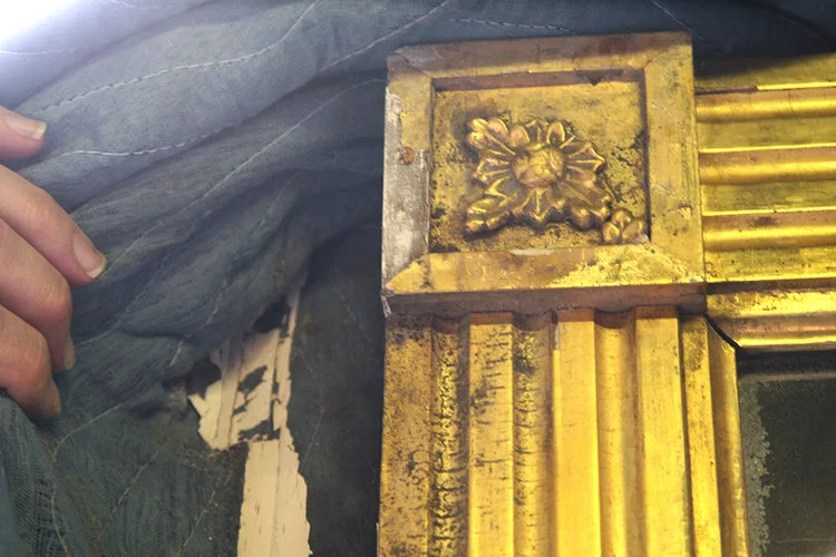 ... An oil-gilded mirror measuring seventy-five inches high and seventy-eight inches wide was stored and locked for several months at private storage facility on the top floor of a warehouse building. The mirror had been blanket wrapped with moving pads loosely taped along the folds, and placed in a plywood crate fastened together by screws. The crate and mirror were staged upright against a partition wall in close proximity to a skylight ... Read full story...