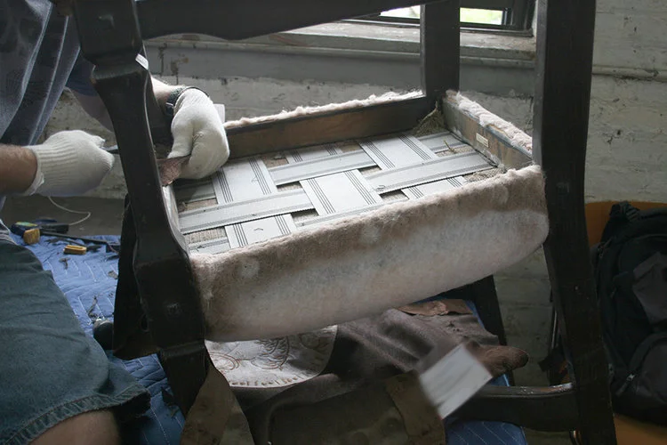 Continuing the disassembling of the chair for assessment and treatment