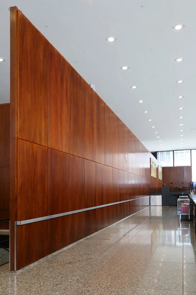 North wall segment viewed after conservation and preservation effort made by the installation of the stainless steel rail attached to the wall in the narrow reveal spaces without damaging the panels. | Photo courtesy of GSA