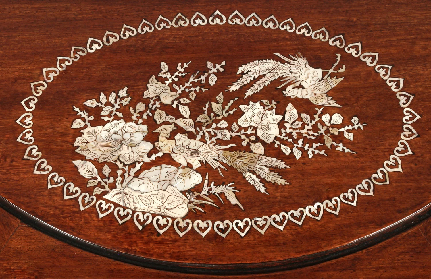 Mother-of-pearl inlay detail after losses were infilled and the surface cleaned