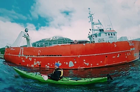 A picture of my dad shot on a GoPro as we kayaked in a fjord.