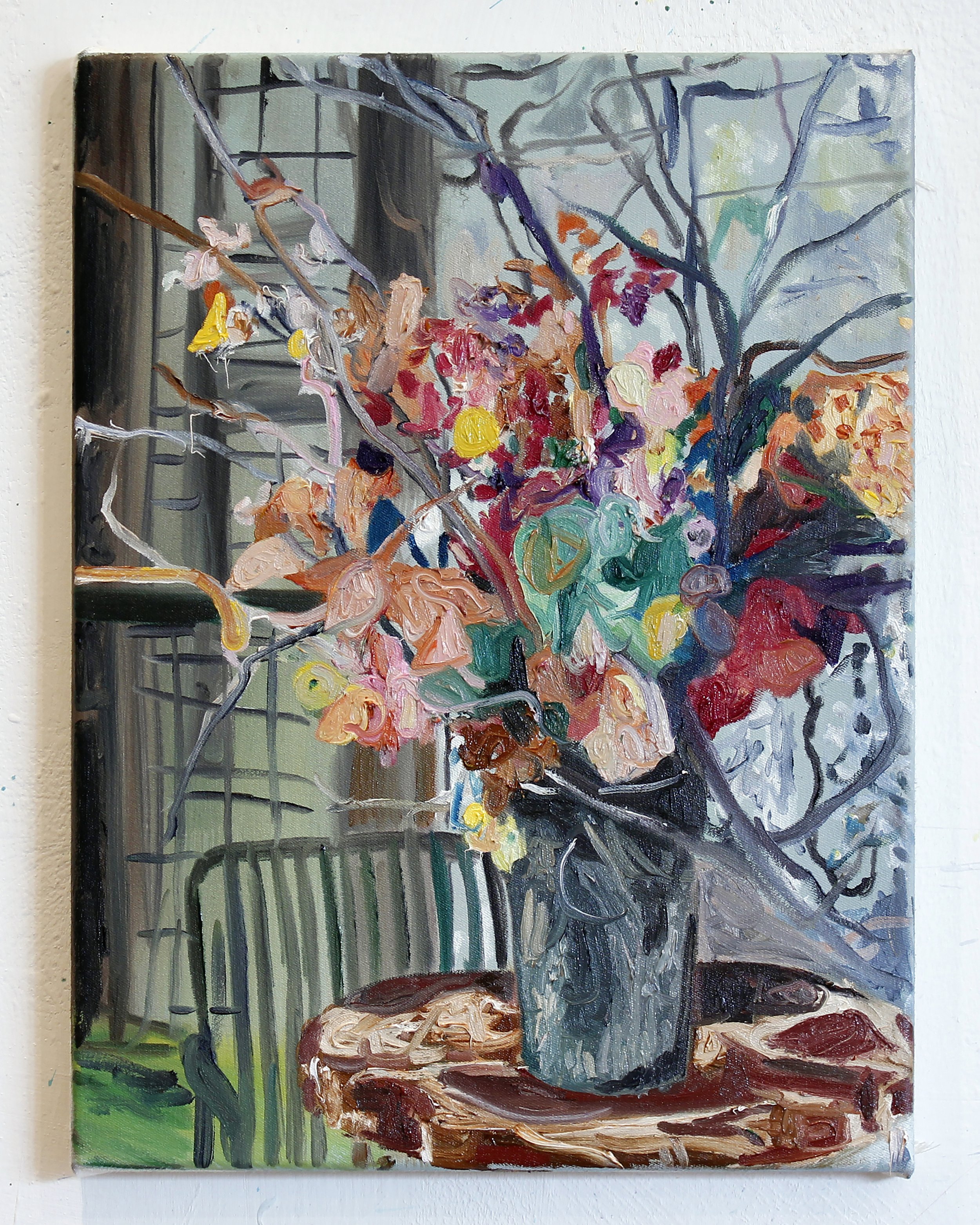 A colorful painting of a bouquet of flowers in a vase on a wooden table, with a background of a window and grid-like metal fence.