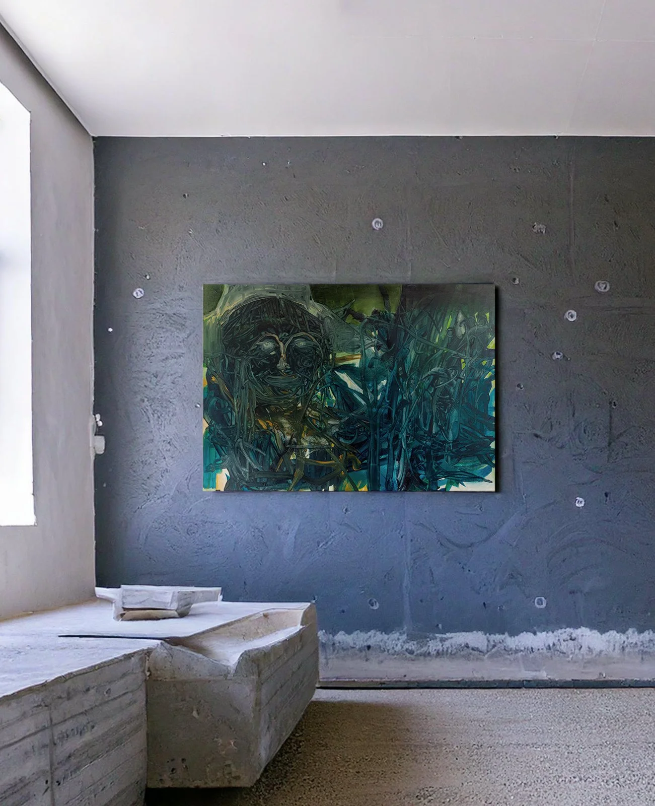 An abstract painting of a smiling face with dark, thread-like lines, hung on a textured gray wall in a modern, minimalist room with concrete seating and a window to the left.