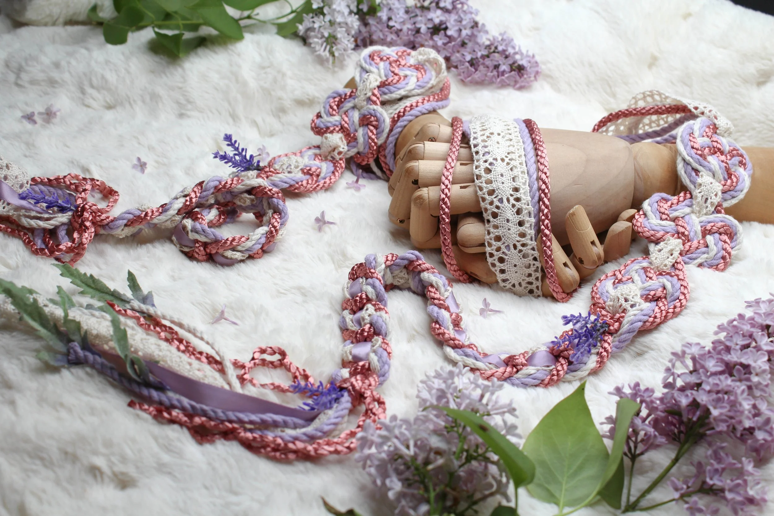 Handfasting cord in lavender, natural cotton and rose, with cream lace ribbon woven through it and lavender floral accents