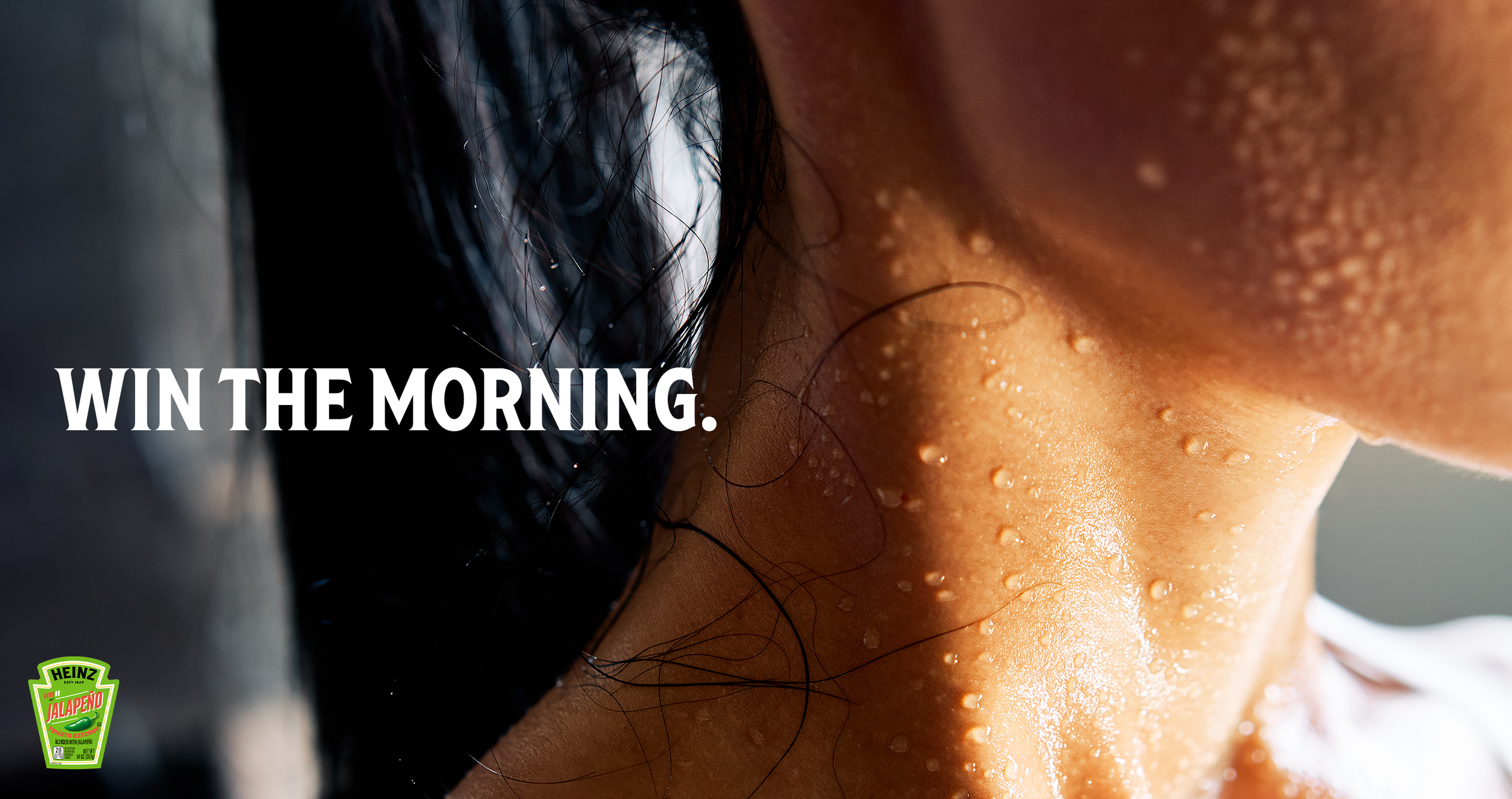 Speculative advertisement showing a close-up of a person's neck and jawline covered in beads of sweat. White text "WIN THE MORNING." is centered on the left. A Heinz Jalapeno Ketchup logo is visible in the bottom left corner.