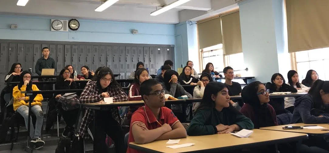AP Capstone students evaluate a classmate’s presentation on financial instability in the modern era. Photo Credit: Haseeb Khan