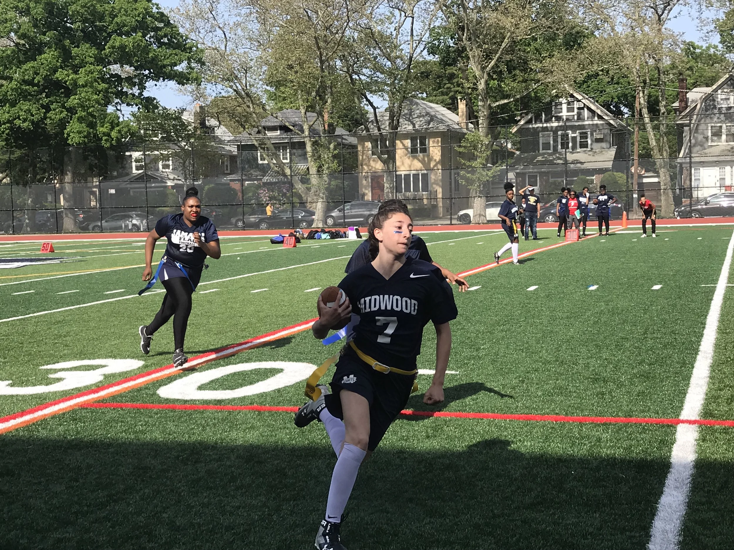 Quarterback Alex Dadario ’19 rushes past Jamaica’s defense. Photo Credit: Anisa Kaloshi