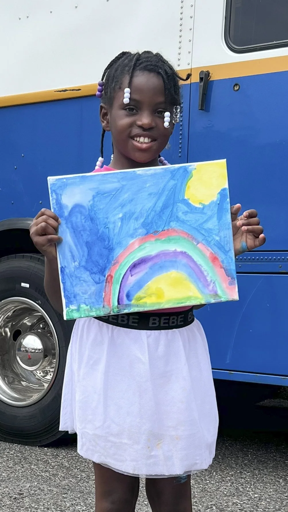 A Young TCAT Artist with Her Rainbow Artwork