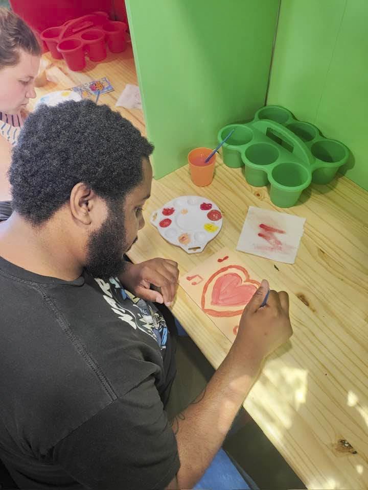 TCAT Art Cart Artist Painting a Heart