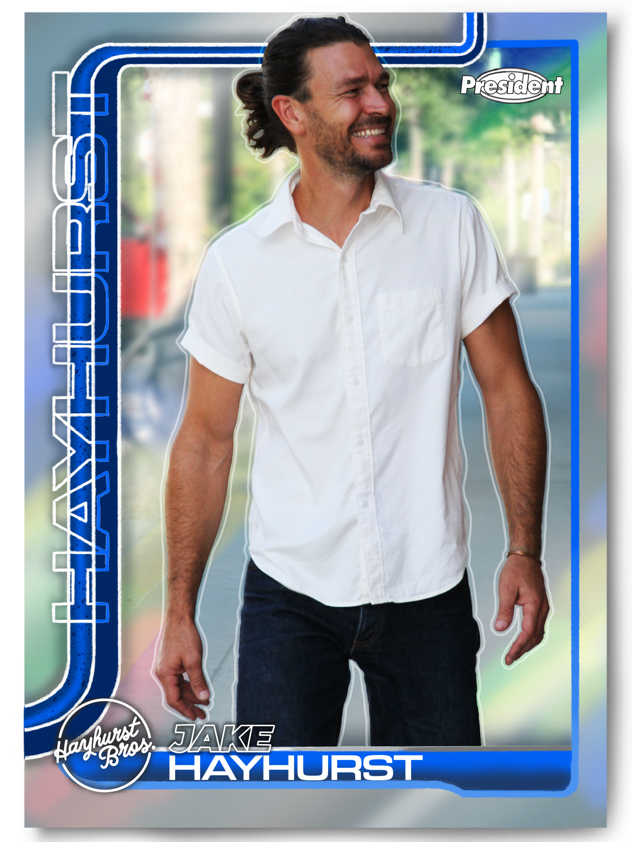 A promotional image featuring a man with long hair and a beard, wearing a white shirt, smiling. The background shows a blurred outdoor scene with trees. The image includes blue and white text and graphics related to Hayhurst Bros JAKE HAYHURST.