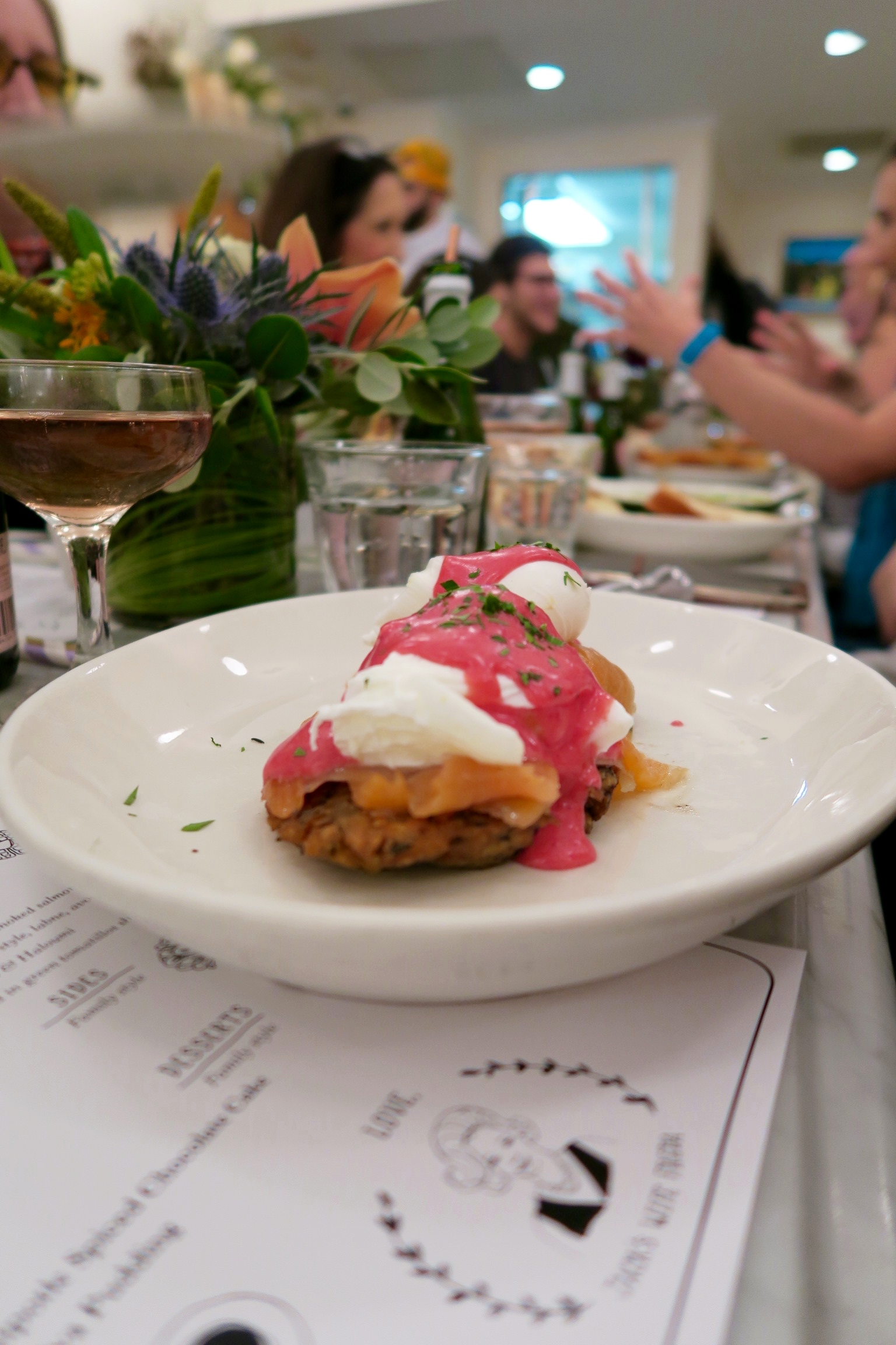 Eggs Benny Two poached eggs over potato latkes, smoked salmon, and beet hollandaise