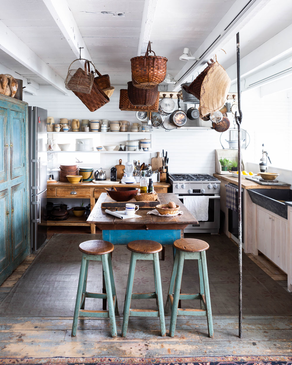 The Mrozinskis cook every meal together, and it shows. Well-used pots and pans. Knife marks in the butcher’s block. A prep-slash-dining table. This is clearly a working kitchen, even with its whimsical basket and pottery displays.