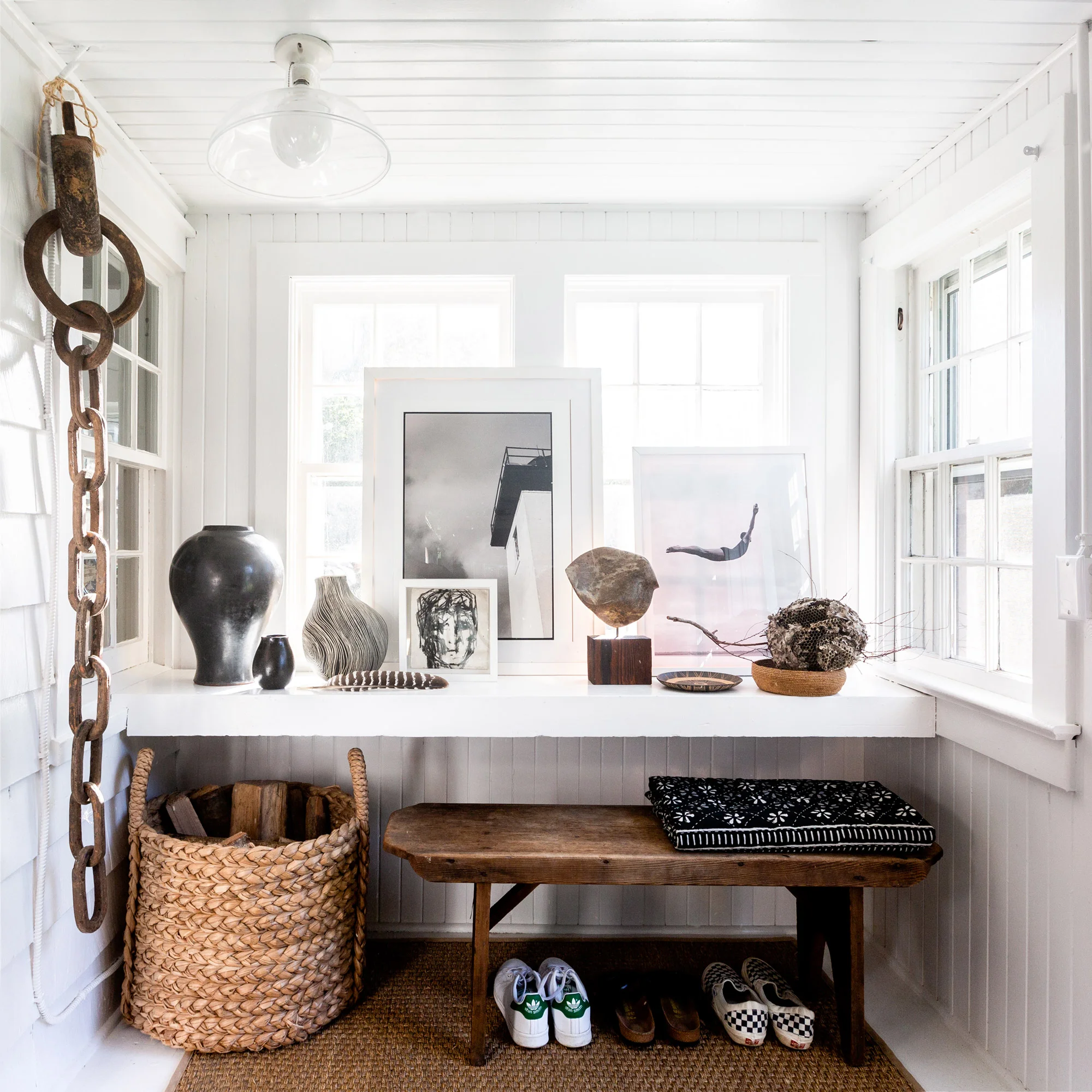 Ban’s shoes sit alongside his son’s beneath an antique bench. (“I really love stools; they’re great for putting things on, and they’re easy enough to tuck away,” he says.) Meanwhile, an exhibit of internationally foraged natural treasures and art purchases sits atop the window ledge. “I am a known collector of objects and things,” Ban laughs.