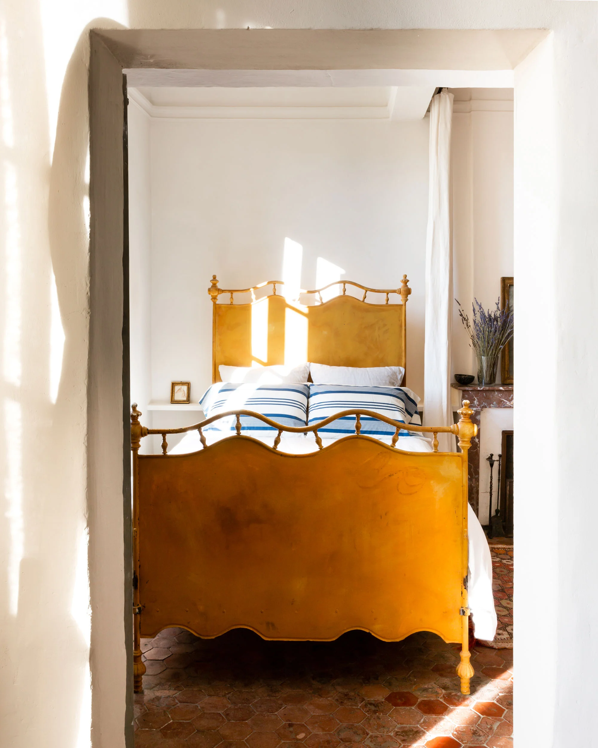 In 2011, Sharon and Paul added to the layout of their Provençal retreat by purchasing a cozy adjoining studio, which was also once part of the much larger, long-ago-divided 14th-century construction. “That space is a bit of a hidden chamber,” Sharon says. Concealed behind two doors, with its own open kitchen and a tiny bathroom, the sun-dappled studio is a semi-secret, entirely private suite. “Afternoon naps with the curtains drawn. Late nights, reading with the windows open. It’s just lovely.”