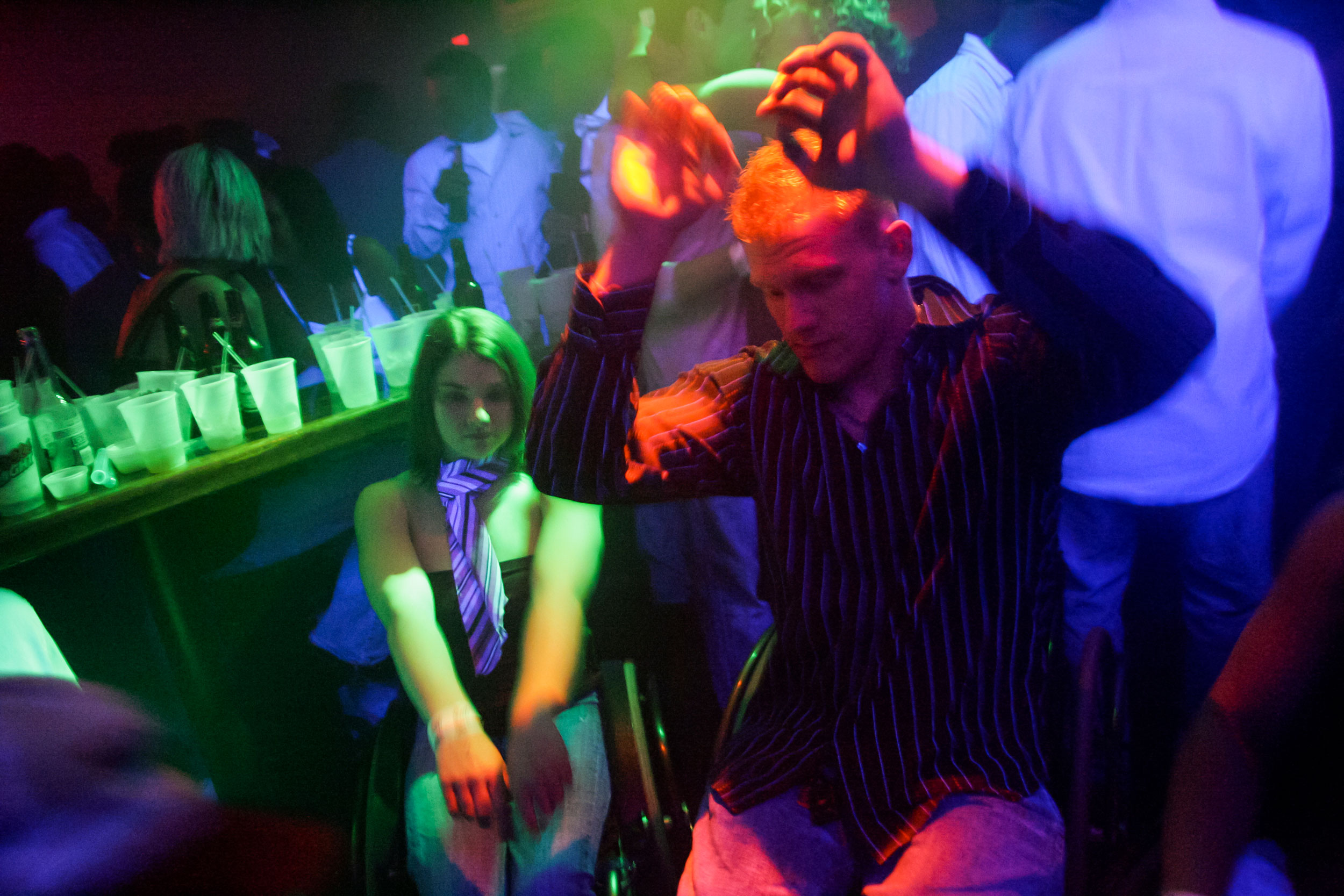 Matt Buchi dances with women's track athlete Jessica Galli at Joe's Brewery in Champaign, Ill., for a night out to celebrate his 21st birthday. Despite the difficulty of getting into crowded bars, they still go.