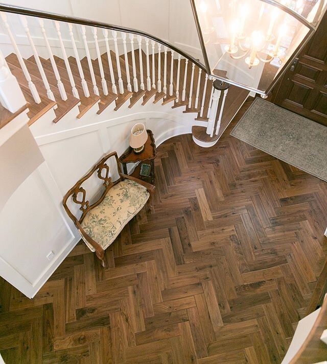 This entryway with herringbone pattern wood floors is one of our favorites in a home we built in La Canada, CA.