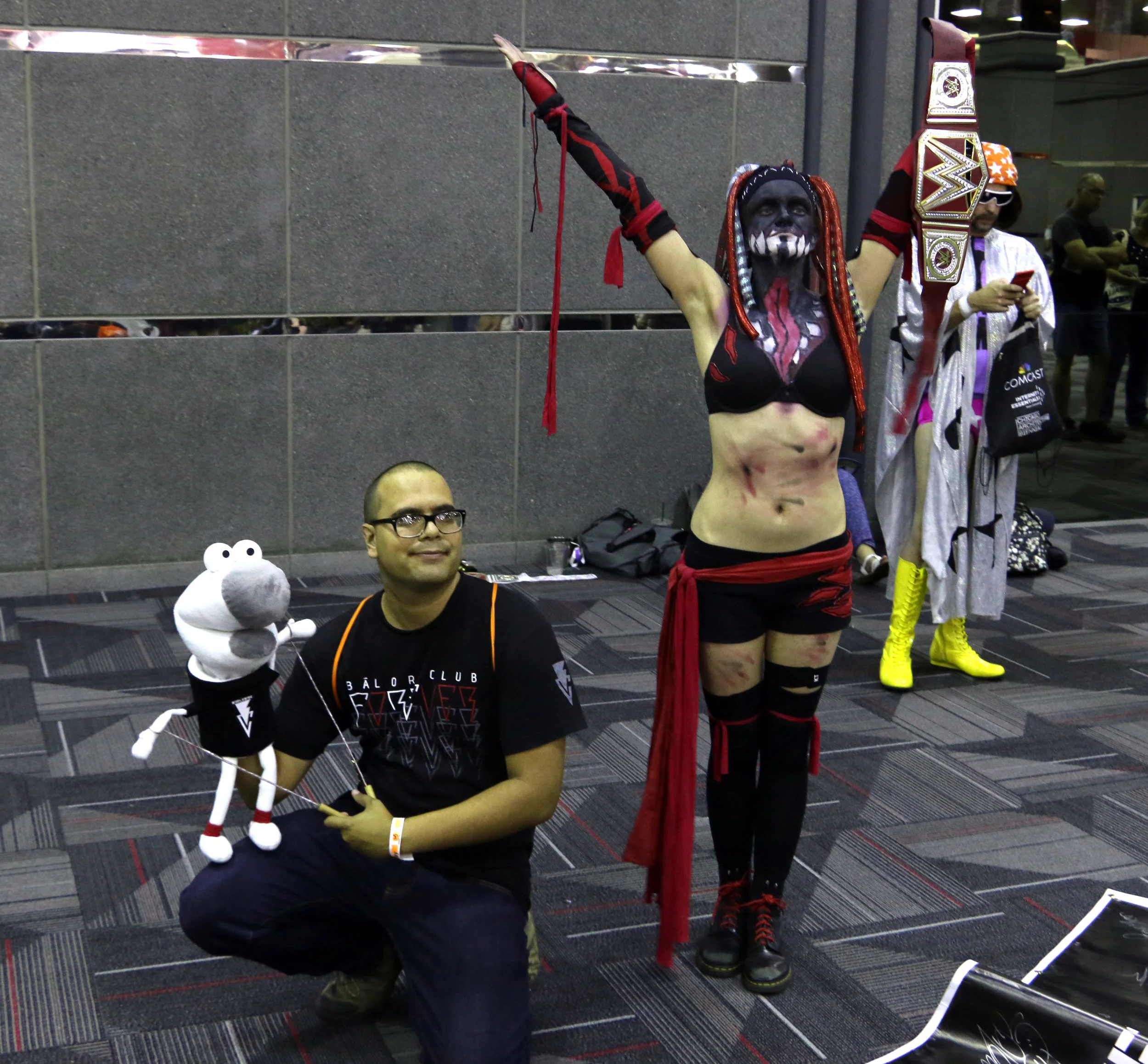 Alejandro Rivera (with Socky the Sock Puppet), left, and Senna Chandra Fenette, who cosplayed as "The Demon King" version of Finn Balor, pose at Wizard World Chicago at the Donald E. Stephens Convention Center on Saturday, August 25, 2018. (Photo by Mike Pankow)