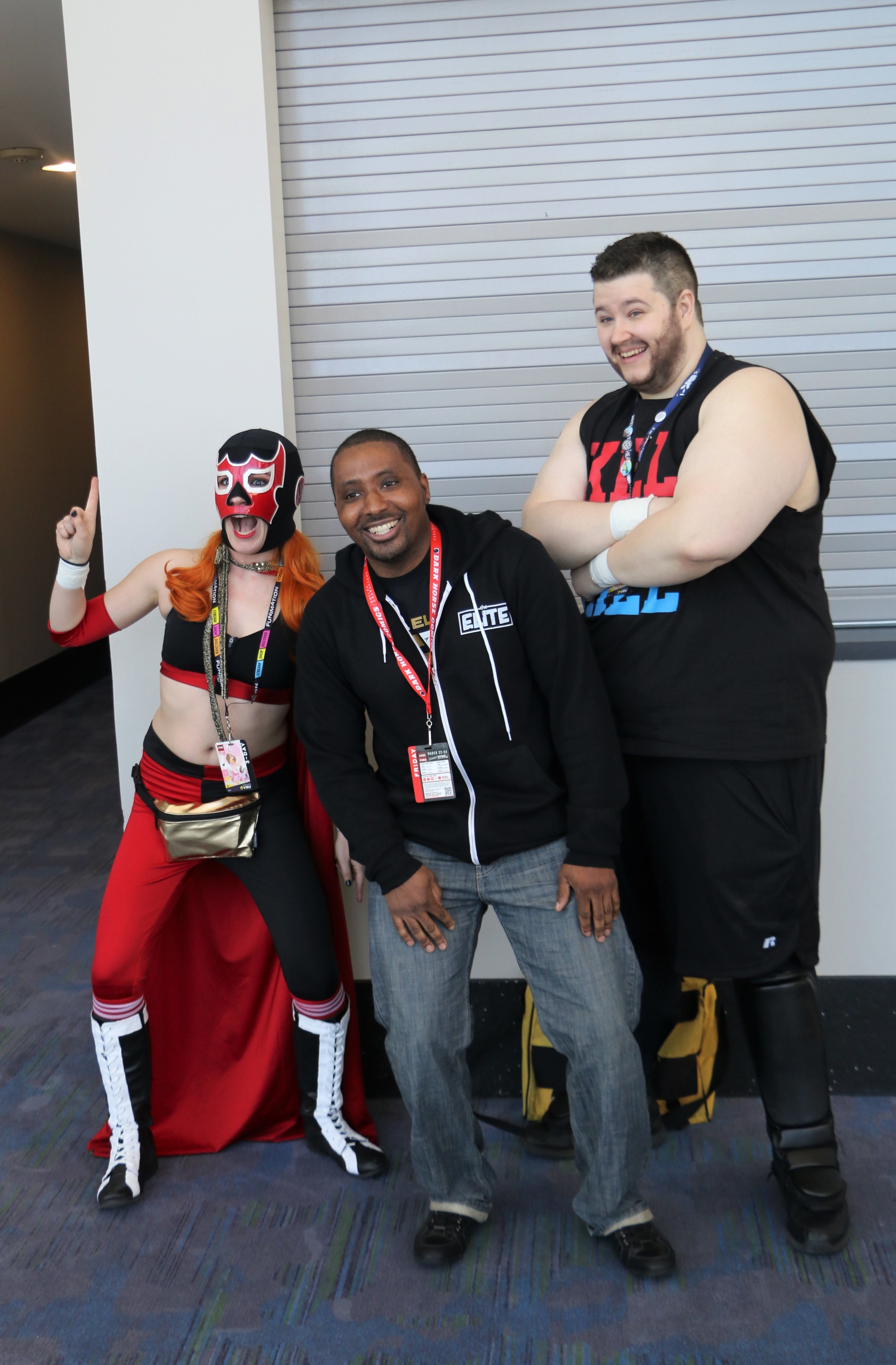  A fan poses with the El Generico and Kevin Steen cosplayers. 